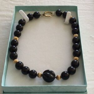 Woman’s Onyx Necklace Showcases a striking combination of black & gold bead